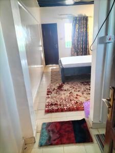 a bedroom with a bed and a rug on the floor at Olympic Lamu sea front house - 2 bedroom All ensuite in Lamu