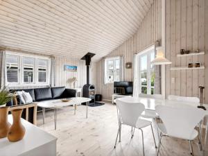 a living room with a white table and chairs at Holiday home Hemmet VI in Hemmet