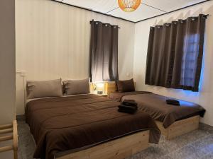 a bedroom with two beds and a window at U Hostel Koh Phangan in Haad Rin