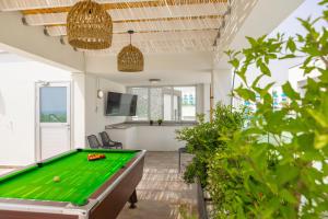 a pool table in the middle of a living room at Fig Tree Bay Residences 4 in Protaras