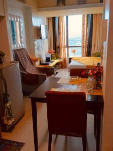 a living room with a table and a living room with a couch at #26 Congresional Town Center in Manila