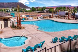 a large swimming pool with chairs and a swimming pool at Canthony's Cottage W301 condo in St. George