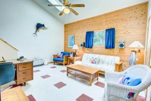 a living room with a couch and a tv at 3065 Hideaway 8 Min Drive to Beach Hot Tub in Southern Shores