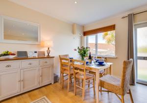 a kitchen and dining room with a table and chairs at Lanngorrow in Saint Merryn