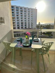 a table and chairs on a balcony with a view of a building at Tamarindo 5 in Benalmádena