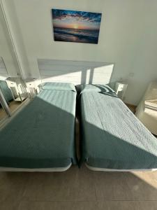 a bedroom with two beds sitting next to a window at Tamarindo 5 in Benalmádena