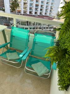 two blue chairs sitting on a balcony at Tamarindo 5 in Benalmádena