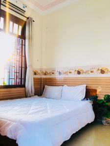 Ένα ή περισσότερα κρεβάτια σε δωμάτιο στο Thu Trang Homestay Cu Lao Cham