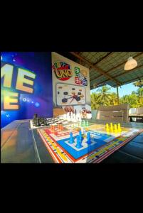 a game room with a table with a chess board at Cornerpoint bungalows in Alibaug
