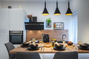 a kitchen with a wooden table with glasses of wine at Lux Maximus in Pula