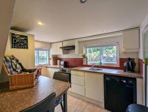 a kitchen with a table and a counter top at The Casey in Fenny Bentley