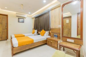 a bedroom with a bed and a mirror at Hotel Prime in Ahmedabad