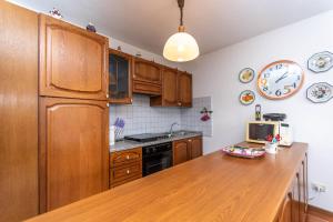 a kitchen with wooden cabinets and a wooden counter top at Maison Miravalle in Colle Santa Lucia +14 photos