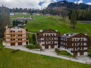 a group of buildings on a grassy hill at Maison Miravalle in Colle Santa Lucia