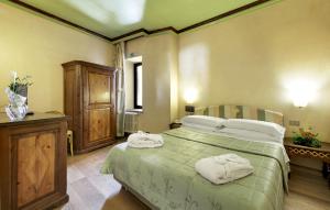 Cama o camas de una habitación en Hotel Club Relais Des Alpes