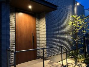 a wooden door on the side of a building at Leaf Village in Tokorozawa