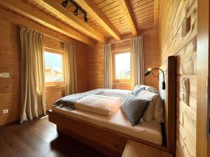 a bedroom with a bed in a wooden room at Bergchalet Raffalt in Rohrmoos