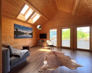 a living room with a couch and a large tree stump at Bergchalet Raffalt in Rohrmoos