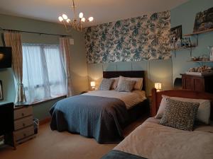 a bedroom with two beds and a window at Oak Tree Lane Country B and B in Bridgetown