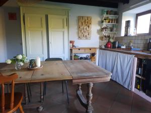 a kitchen with a wooden table in a room at Biert La Coume 2 persoonsbed in Biert