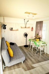 a living room with a couch and a table at Single Fin Conil in Conil de la Frontera