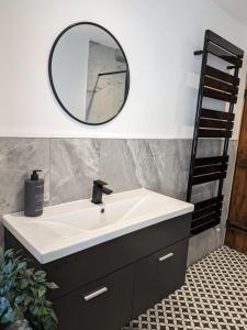 a bathroom with a sink and a mirror at The Barn in Shirland