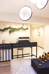 a bar with a table and a chair in a room at L'Agapa Hôtel - Spa Codage in Perros-Guirec