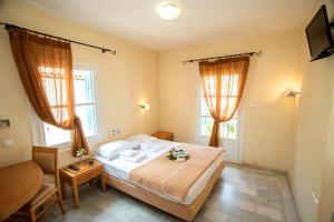 Postel nebo postele na pokoji v ubytování Hotel Argo