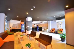 a lobby of a hospital with chairs and tables at H2 Hotel in Bangkok