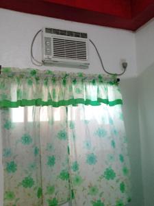 a room with a window with a air conditioner at Jammer's Pension in El Nido