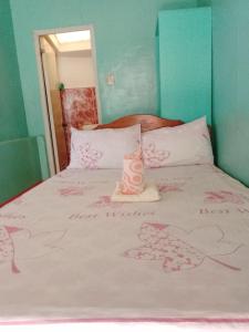 a bedroom with a bed with a candle on it at Jammers Pension House in El Nido