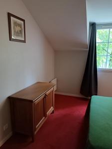 um quarto com uma cama, uma cómoda e uma janela em Petite maison dans Résidence em Monflanquin