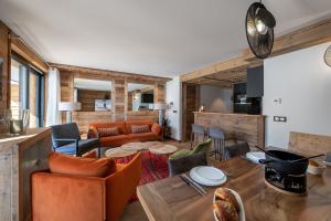 a living room with a couch and a table at Appartement Fusée - LES CHALETS COVAREL in Le Joseray +10 photos