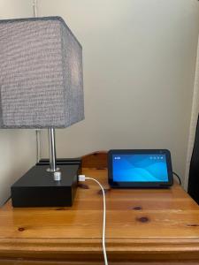 a laptop computer sitting on a table next to a lamp at Leamington Loft in Leamington Spa