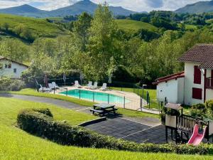 a backyard with a swimming pool and a house at MEHATCHE Piscine Vue Montagnes in Souraïde