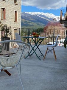 two chairs and a table with a bowl of fruit on it at Très beau studio avec terrasse in Zonza