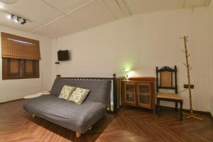 a living room with a couch and a table at Ohana House @ 31 Jawa in Melaka