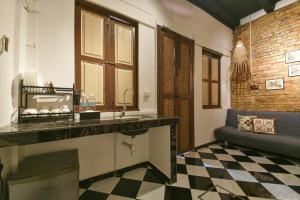 a bathroom with a sink and a checkered floor at Ohana House @ 31 Jawa in Melaka