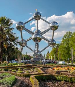 a large metal structure with flowers in a park at The Cosy House in Brussels
