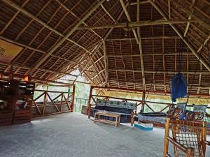 a room with two beds and a table in a building at Karibu Paradaizi in Michamvi