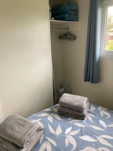 a bedroom with a bed with two towels on it at Margaret Ann Chalet in Seaton