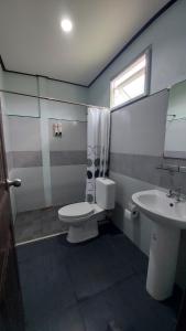 a bathroom with a toilet and a sink at Green Country Park Resort in Ban Tha Mak