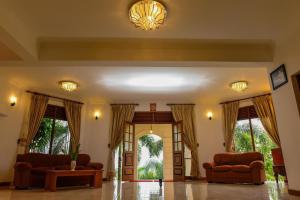 a living room with two couches and an entry way at Siyonra Bungalow in Matale