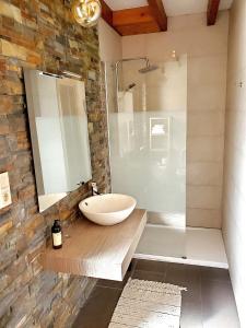 a bathroom with a sink and a glass shower at La Panera in San Vicente de la Barquera