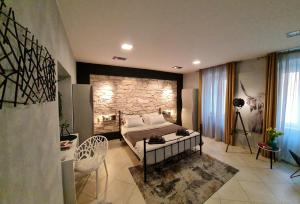 a bedroom with a bed and a stone wall at Apartment Golden Gate in Pula