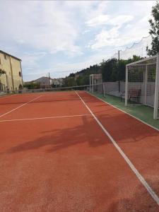 a tennis court with a net on a tennis court at Kuća NIKA in Tribunj