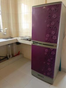a purple refrigerator in a kitchen with a sink at Star Night stay family Studio AC Apartment in Dhaka +1 photo