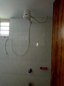 a shower with a shower head in a bathroom at Star Night stay family Studio AC Apartment in Dhaka