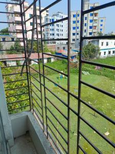 a view from a window of a field with buildings at Star Night stay family Studio AC Apartment in Dhaka