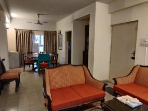 a living room with two couches and a table at Lovely couple friendly guest house in Kolkata
